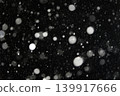 White snowflakes on a black background. Winter snow background.  139917666