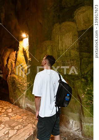 A 30 year old Russian male tourist explores a mystical limestone cave inside the Marble Mountains near Da Nang in Quang Nam province Vietnam A 30 year old Russian male tourist explores a mystical limestone cave inside the Marble Mountains near Da Nang in Quang Nam province Vietnam 139917673