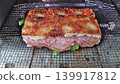 A generously filled salami focaccia sandwich, grilled to perfection over a fire. 139917812