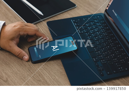 Hand using smartphone with AI interface beside laptop and tablet on office desk, suitable for password security, privacy protection, artificial intelligence authentication, and data protection Hand using smartphone with AI interface beside laptop and tablet on office desk, suitable for password security, privacy protection, artificial intelligence authentication, and data protection 139917850