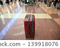 Red travel suitcases placed in airport and train station lobbies 139918076