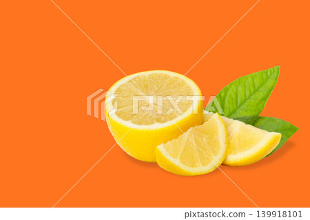 Fresh lemon cut into pieces with green leaves present Fresh lemon cut into pieces with green leaves present 139918101