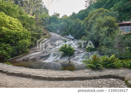 View of the spectacular waterfall flowing between rocks on the Barosa Mills Trail in Galicia 139918427