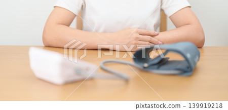 woman checking Blood pressure by Blood pressure monitor with Cuff. Systolic, SYS, Diastolic, DIA, Pulse, Hypertension, Hypotension, Heart rate, Cardiovascular Disease and May World hypertension day woman checking Blood pressure by Blood pressure monitor with Cuff. Systolic, SYS, Diastolic, DIA, Pulse, Hypertension, Hypotension, Heart rate, Cardiovascular Disease and May World hypertension day 139919218