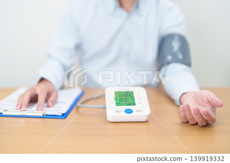 Man checking Blood pressure by Blood pressure monitor with Cuff. Systolic, SYS, Diastolic, DIA, Pulse, Hypertension, Hypotension, Heart rate, Cardiovascular Disease and May World hypertension day Man checking Blood pressure by Blood pressure monitor with Cuff. Systolic, SYS, Diastolic, DIA, Pulse, Hypertension, Hypotension, Heart rate, Cardiovascular Disease and May World hypertension day 139919332