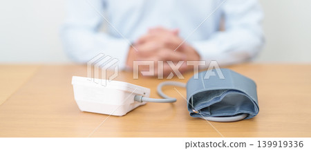 Man checking Blood pressure by Blood pressure monitor with Cuff. Systolic, SYS, Diastolic, DIA, Pulse, Hypertension, Hypotension, Heart rate, Cardiovascular Disease and May World hypertension day Man checking Blood pressure by Blood pressure monitor with Cuff. Systolic, SYS, Diastolic, DIA, Pulse, Hypertension, Hypotension, Heart rate, Cardiovascular Disease and May World hypertension day 139919336