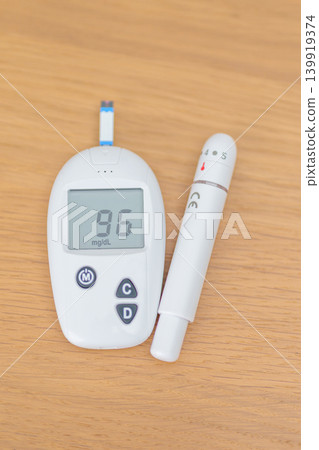 digital blood glucose meter with lancet pen on table. Diabetes checking or Blood glucose self testing, blood sugar level, World Diabetes Day, Glycemia, Hypoglycemia, Hyperglycemia and insulin digital blood glucose meter with lancet pen on table. Diabetes checking or Blood glucose self testing, blood sugar level, World Diabetes Day, Glycemia, Hypoglycemia, Hyperglycemia and insulin 139919374
