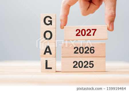 hand pulling 2025 block over 2026 and 20267 wooden building on table background. Business planning, Risk Management, Resolution, strategy, solution, goal, New Year New You and happy holiday concepts hand pulling 2025 block over 2026 and 20267 wooden building on table background. Business planning, Risk Management, Resolution, strategy, solution, goal, New Year New You and happy holiday concepts 139919464