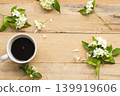 hot black coffee with white flowers jasmine on background wooden 139919606