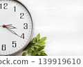 white clock in afternoon with leaf arrangement flat lay postcard style 139919610