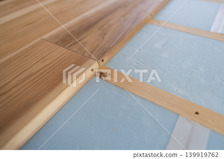 DIY project for home renovation: Laying solid cedar wood flooring over polystyrene insulation under the floor. DIY project for home renovation: Laying solid cedar wood flooring over polystyrene insulation under the floor. 139919762