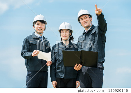Male and female construction workers at a construction site Male and female construction workers at a construction site 139920146
