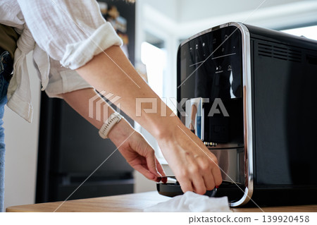 Person cleaning coffee machine drip tray Person cleaning coffee machine drip tray 139920458