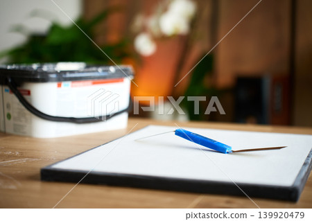 Palette knife placed on blank canvas for art project Palette knife placed on blank canvas for art project 139920479