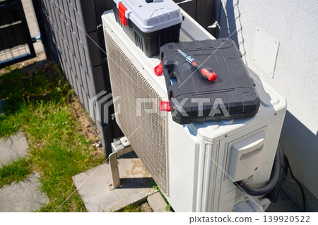 Screwdriver and toolboxes on outdoor HVAC unit 139920522