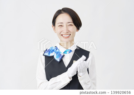 Female staff member, receptionist/bus guide, applause, white background. Female staff member, receptionist/bus guide, applause, white background. 139920656