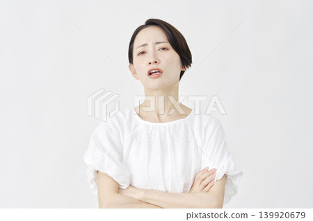 Middle-aged woman, angry, white background. Middle-aged woman, angry, white background. 139920679