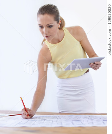 Tablet, architect and woman with blueprint, drawing or sketch at desk in startup office. Technology, engineer and creative designer with pencil on paper for planning construction project for building Tablet, architect and woman with blueprint, drawing or sketch at desk in startup office. Technology, engineer and creative designer with pencil on paper for planning construction project for building 139920820