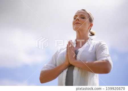 Happy woman, yoga and meditation in spiritual wellness or faith with cloudy sky background. Female person or yogi meditating or hands together for praying, hope or awareness with fresh air in nature Happy woman, yoga and meditation in spiritual wellness or faith with cloudy sky background. Female person or yogi meditating or hands together for praying, hope or awareness with fresh air in nature 139920870