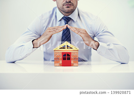 Businessman, insurance and home model for mortgage, asset and secure policy premium for house. Male person, broker and confident for idea, office and realtor for protection and liability coverage Businessman, insurance and home model for mortgage, asset and secure policy premium for house. Male person, broker and confident for idea, office and realtor for protection and liability coverage 139920871