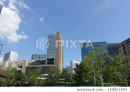 A cluster of skyscrapers stands tall in Osaka, a city teeming with the beauty of fresh greenery. A cluster of skyscrapers stands tall in Osaka, a city teeming with the beauty of fresh greenery. 139921983