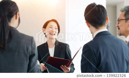 A group of business professionals of various ages, both male and female, meeting A group of business professionals of various ages, both male and female, meeting 139922326