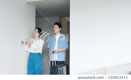 A couple enters the room with smiles on their faces. A couple enters the room with smiles on their faces. 139922411