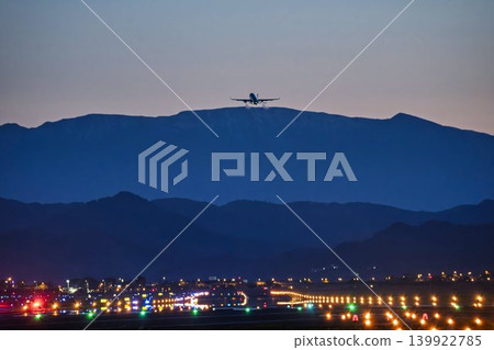 Sendai Airport at dusk, with a plane taking off and the Zao mountain range in the background. Natori City, Miyagi Prefecture. Sendai Airport at dusk, with a plane taking off and the Zao mountain range in the background. Natori City, Miyagi Prefecture. 139922785