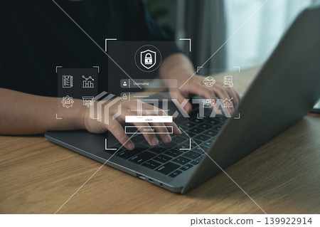 Modern person using digital technology with security icons, secure login, and online data protection on laptop in contemporary workspace setting Modern person using digital technology with security icons, secure login, and online data protection on laptop in contemporary workspace setting 139922914