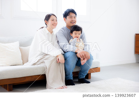 Baby and parents playing in the living room Baby and parents playing in the living room 139923607