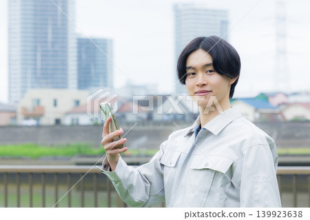 Worker looking at his smartphone Worker looking at his smartphone 139923638