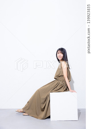 A woman in a khaki dress A woman in a khaki dress 139923835