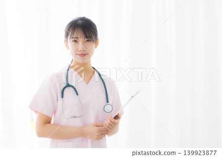 young female nurse in a white coat young female nurse in a white coat 139923877