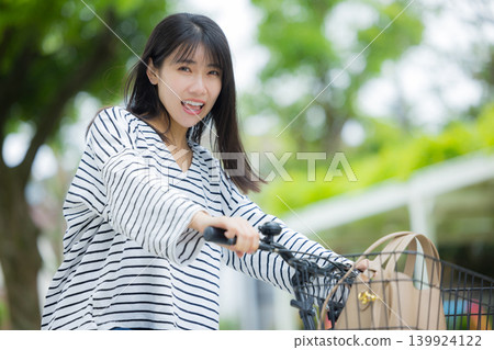 Woman riding a bicycle Woman riding a bicycle 139924122
