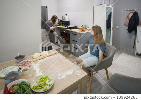 Female family together in domestic kitchen. Mother and daughter preparing food at home Female family together in domestic kitchen. Mother and daughter preparing food at home 139924265