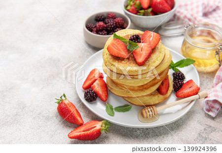 Stack of pancakes with fresh berries and honey for breakfast Stack of pancakes with fresh berries and honey for breakfast 139924396
