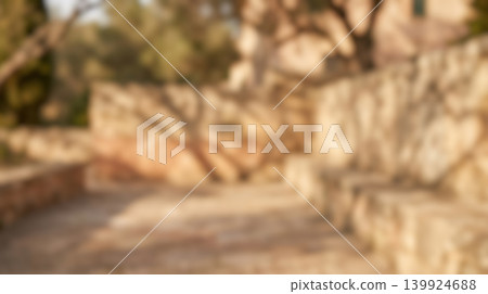 Blurred outdoor background featuring warm bright sunlight hitting natural rustic stone wall covered with dark beautiful tree shadows during peaceful summer morning Blurred outdoor background featuring warm bright sunlight hitting natural rustic stone wall covered with dark beautiful tree shadows during peaceful summer morning 139924688