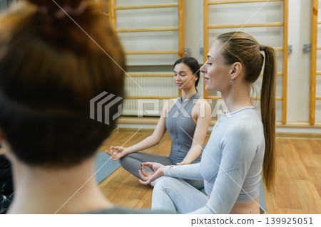 Women Meditating During Yoga Class In Gym Studio 139925051