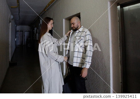 Couple standing in hallway with elevator Couple standing in hallway with elevator 139925411