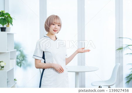 Female staff with light-colored hair serving customers Female staff with light-colored hair serving customers 139927456