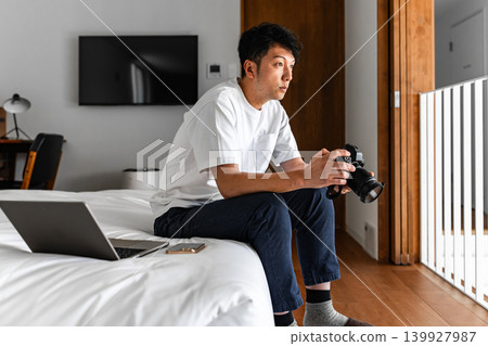 Man, camera, laptop, bedroom 139927987
