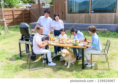 A family enjoying a barbecue in the garden A family enjoying a barbecue in the garden 139928067
