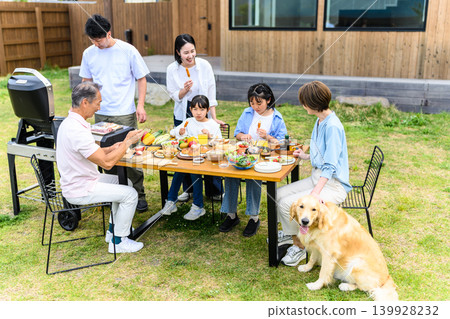 A family enjoying a barbecue in the garden A family enjoying a barbecue in the garden 139928232