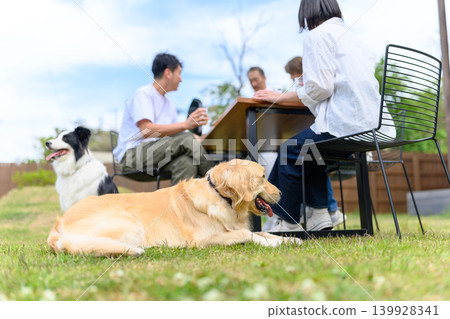 People and dogs relaxing in the garden People and dogs relaxing in the garden 139928341