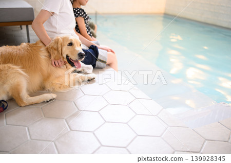 A dog and child relaxing by the poolside. A dog and child relaxing by the poolside. 139928345