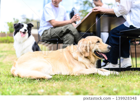 Outdoor scene of a dog and a person relaxing. Outdoor scene of a dog and a person relaxing. 139928348