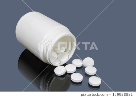 Medical plastic container with white pills Medical plastic container with white pills 139928881