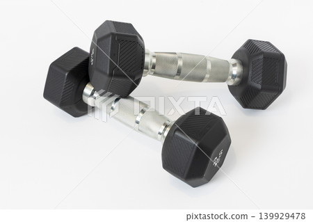 Two dumbbells with chrome handles isolated on white background Two dumbbells with chrome handles isolated on white background 139929478