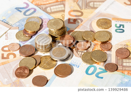 Financial background of a close up of euro banknotes and coins Financial background of a close up of euro banknotes and coins 139929486