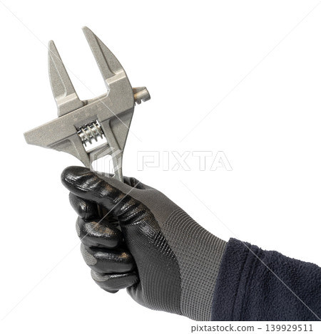 Human hand in work glove holding an adjustable wrench isolated on white background 139929511